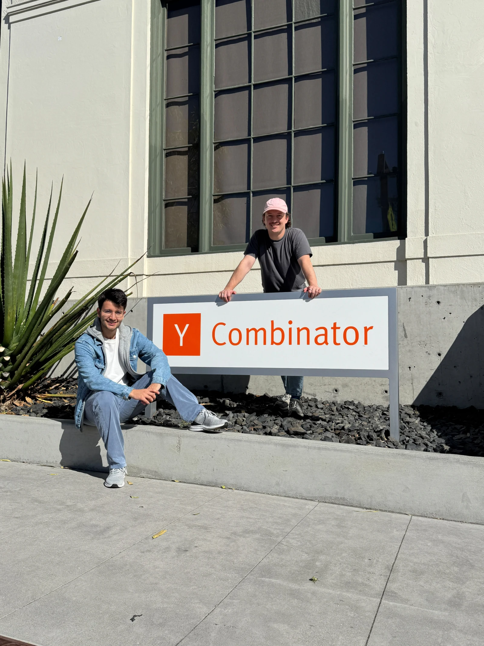 Doruk Tan Öztürk and Fabian Zbinden together beside the Y Combinator sign in San Francisco